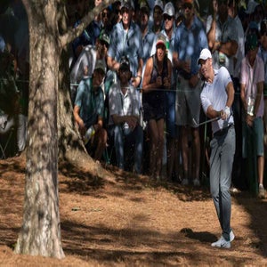 ory McIlroy of Northern Ireland hits a stroke from the pine straw at No. 13 during the second round of the Masters at Augusta National Golf Club, F