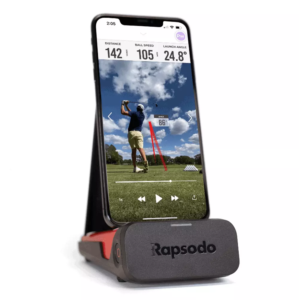 A smartphone on a Rapsodo stand displays a golf swing analysis app, showing a golfer mid-swing on the course with stats like distance, ball speed, and launch angle&mdash;all while highlighting the best deals under $50.