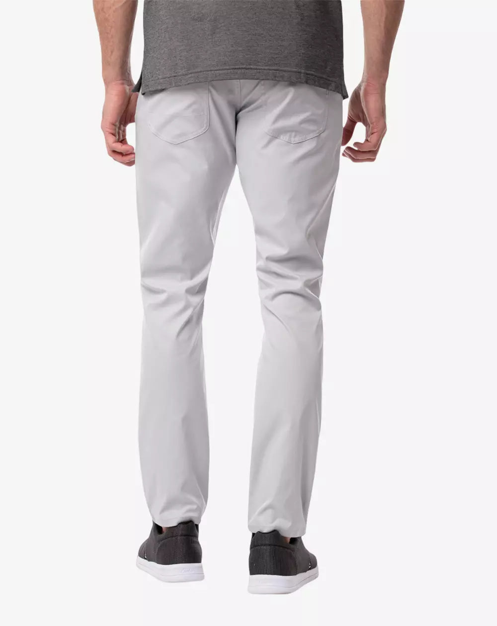 The man is shown in the background wearing light gray pants, a gray t-shirt, and black sneakers with white soles, standing against a stark white background—the perfect outfit for organizing essentials before packing in the best golf bags.