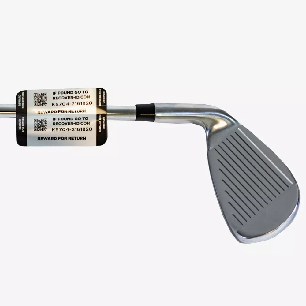 A close-up of a metal golf club iron with a black and silver Lost & Found label on the shaft, displaying QR codes and recovery info&mdash;ideal for golfers looking to keep their gear secure alongside the best golf bags 2026 has to offer.