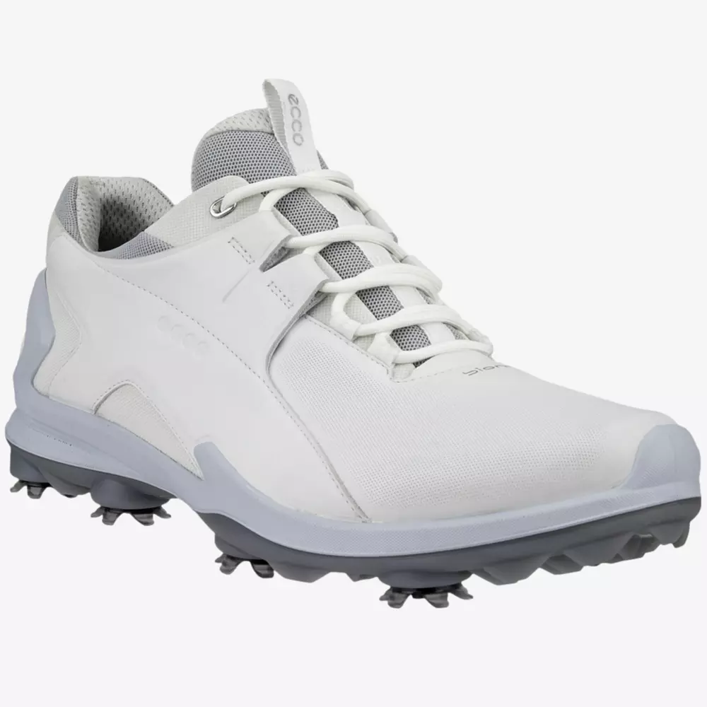 A white athletic golf shoe with gray accents, mesh tongue, and spiked sole designed for traction on grass surfaces&mdash;one of the best golf deals for $100 or less.