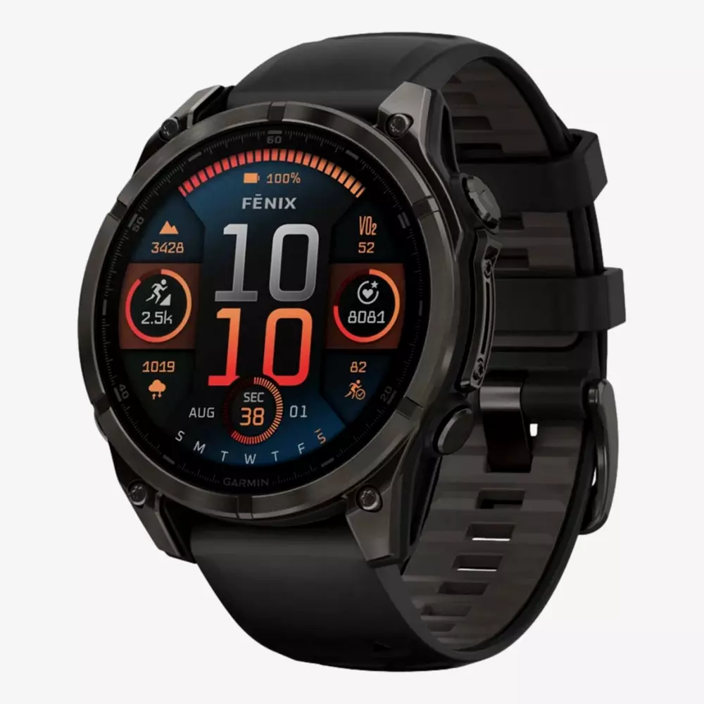 A black Garmin Fenix smartwatch displays time, date, and fitness metrics on a colorful digital screen with a black silicone strap and metallic case&mdash;an ideal accessory to pair with your best golf shorts for stylish course performance.