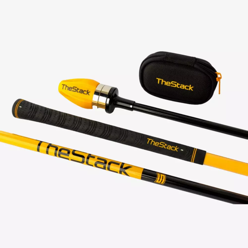 A yellow and black golf swing training aid labeled TheStack, shown disassembled with its parts and a small black carrying case featuring TheStack branding on a white background&mdash;perfect for those seeking the best deals under $50.