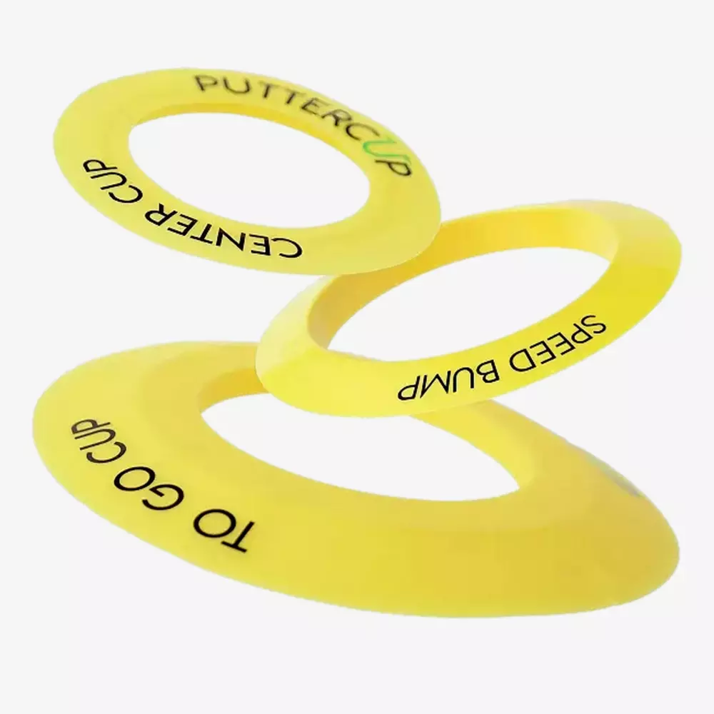 Three yellow plastic rings labeled PUTTER CUP, SPEED BUMP, and TO GO CUP are displayed against a white background, appearing as if they are floating or stacked diagonally&mdash;perfect for those seeking the best deals under $50.