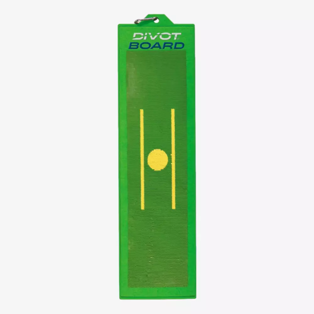 A rectangular green divot board with a yellow circle and two parallel yellow lines in the center, used for golf swing practice. The words DIVOT BOARD appear at the top&mdash;one of the best deals under $50 for golf training aids.