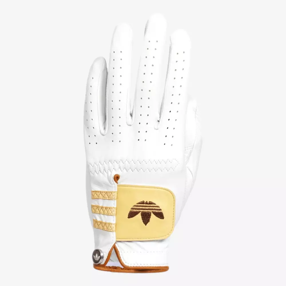 A white golf glove with perforations on the fingers, gold and beige accents, and an embroidered Adidas logo on the wrist strap&mdash;perfectly complementing your style alongside the best golf bags 2026&mdash;displayed palm down against a plain background.