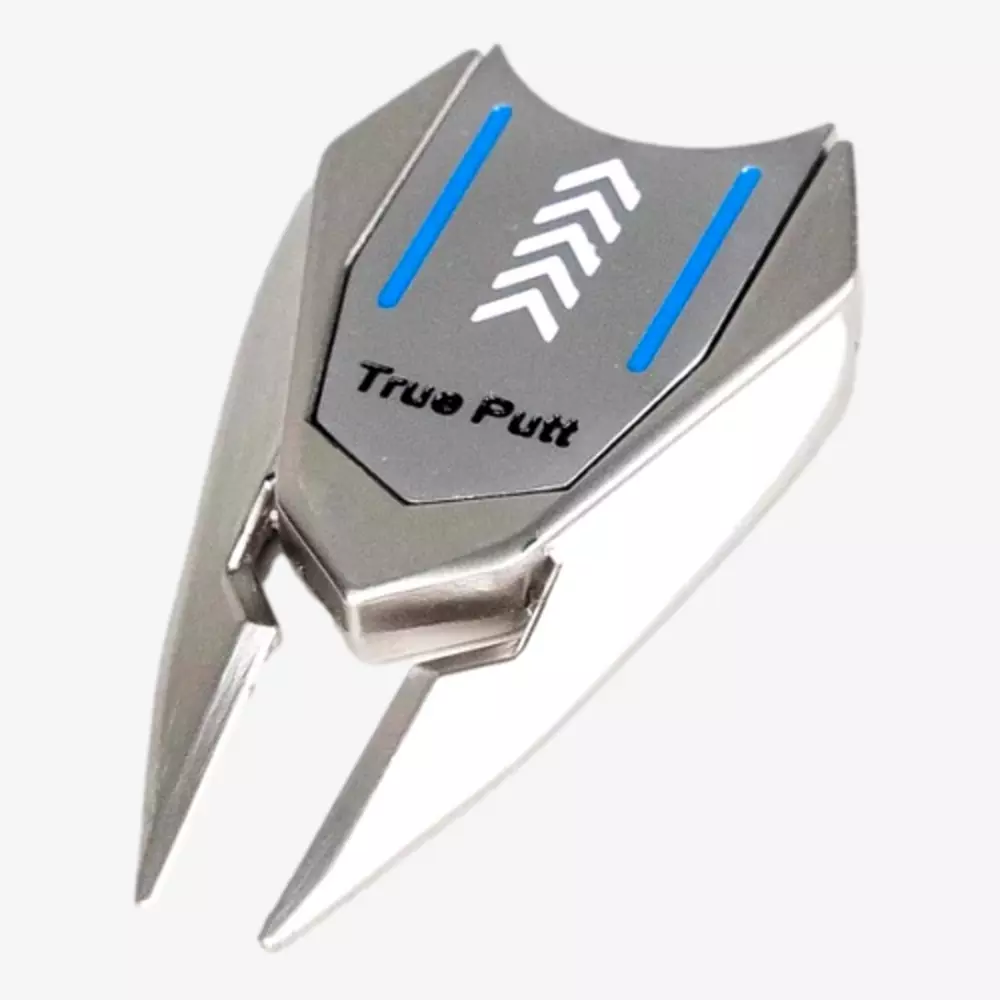 A metallic golf ball marker and divot tool labeled True Putt, featuring two prongs, blue lines, and white arrow designs on a silver surface&mdash;an ideal accessory to pair with the best golf bags 2026 has to offer.