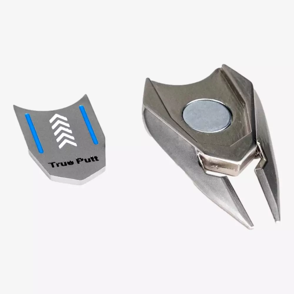 A metallic golf divot repair tool with a removable magnetic ball marker labeled True Putt, featuring blue lines and white arrows&mdash;an ideal accessory for golfers seeking the best golf bags 2026&mdash;shown on a white background.