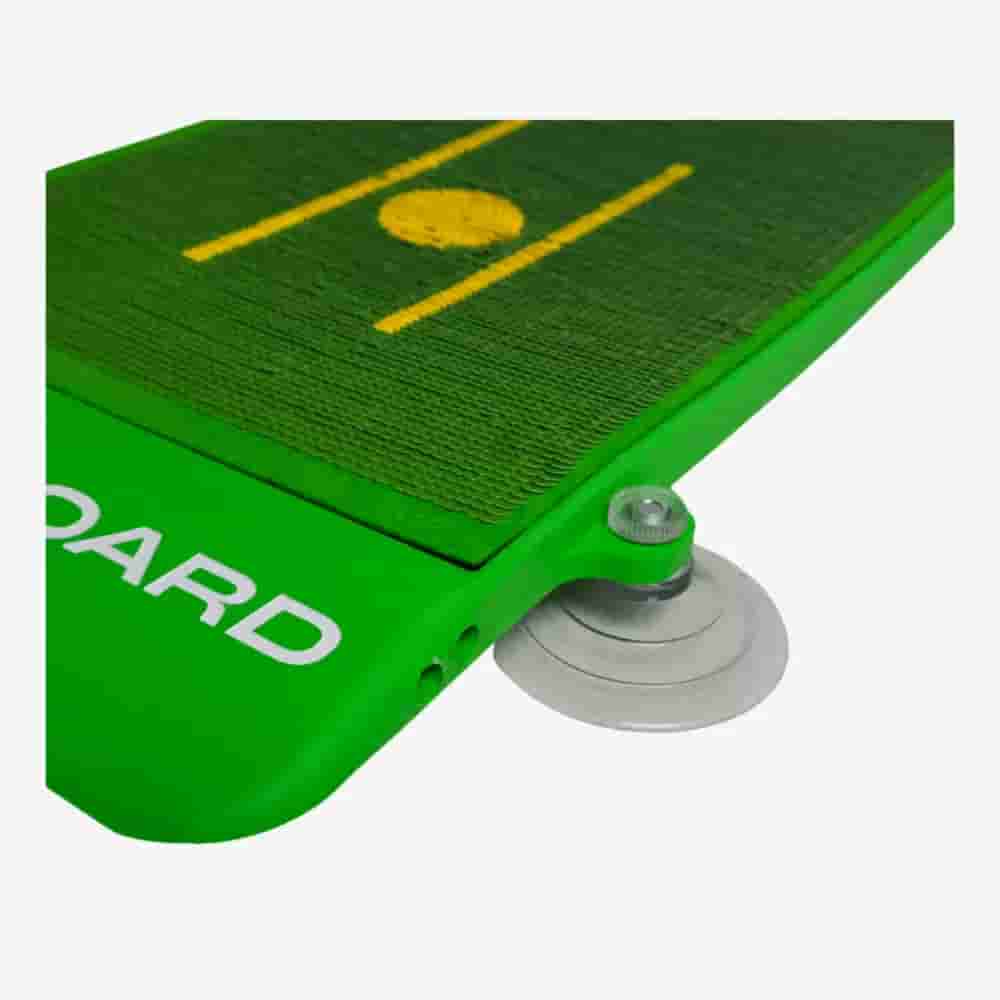 Close-up of a green cricket training board with a yellow pitch design, featuring a metal spring and round base for rebound practice—ideal for sports enthusiasts who also seek the best golf bags 2026 has to offer.