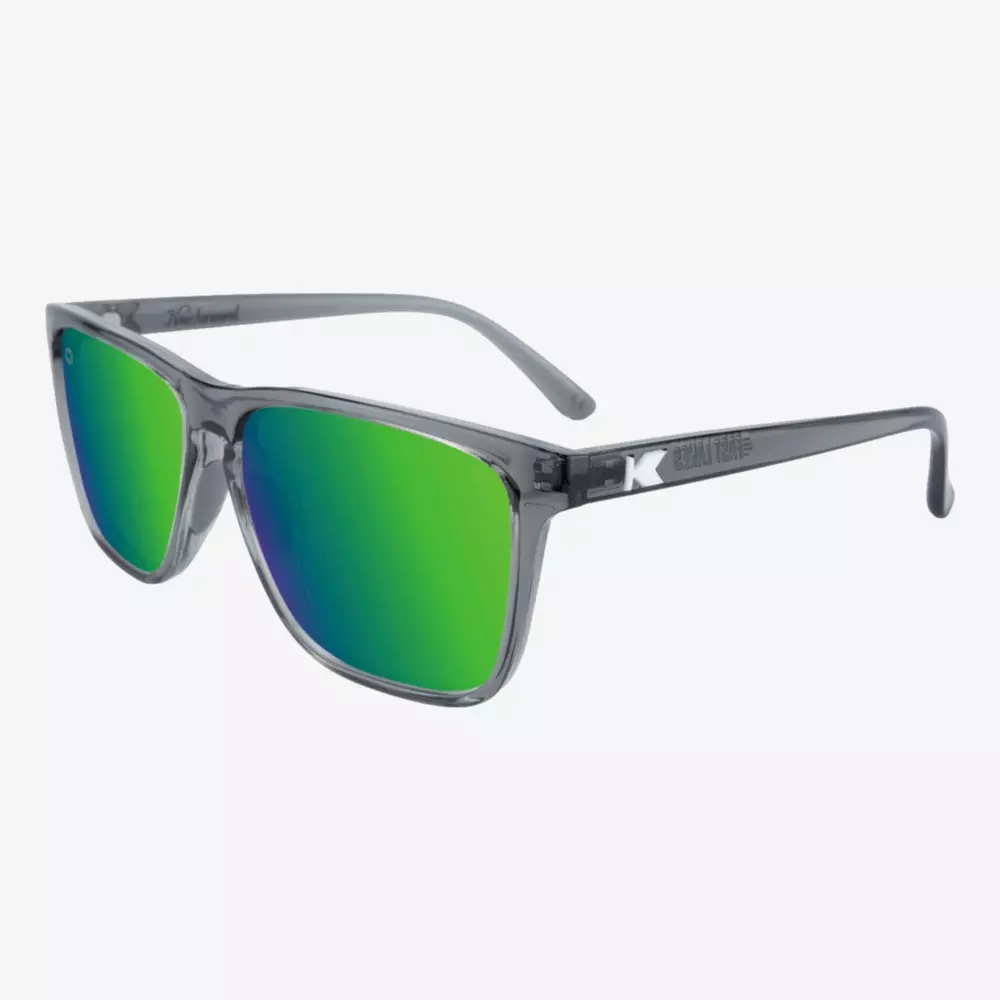 Gray-framed sunglasses with mirrored green lenses, shown at an angle on a white background. Ideal for days on the course or searching for the best golf bags 2026, the frame features a subtle K logo on the temple.