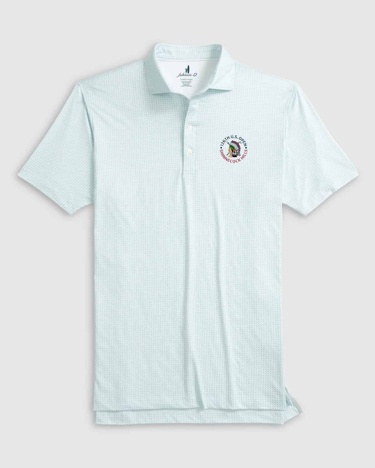 Light blue short-sleeve polo shirt with a subtle pattern, three buttons, and an embroidered circular logo on the left chest featuring text and a colorful graphic. Pair it with the best golf pants for a sharp look on and off the course.