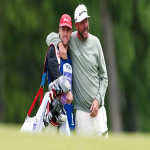 Michael Block of the United States, Corebridge Financial Team of PGA of America and caddie Ethan Block embrace on the tenth hole during the first round of the PGA Championship