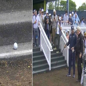 Bryson DeChambeau debates a rules official after hitting a shot into a staircase at the 2026 PGA Championship.