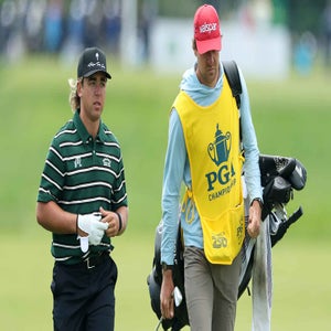 Garrick Higgo of South Africa walks the 16th hole alongside caddie Austin Gaugert during the first round of the PGA Championship at Aronimink Golf Club