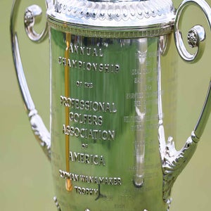 Close-up of the engraved front of the PGA Championship&rsquo;s Wanamaker Trophy, its ornate handles gleaming&mdash;a symbol not only of victory but also the event&rsquo;s impressive purse and historic PGA money legacy.
