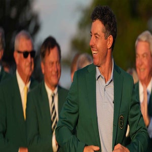 Rory McIlroy smiles while wearing his green jacket at the 2026 Masters