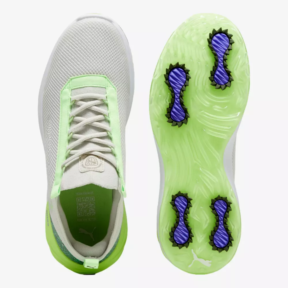 Top and sole view of a light-colored athletic shoe with green accents; the sole is light green with four purple and black cleats for grip&mdash;ideal for pairing with the best golf smartwatch on the course.