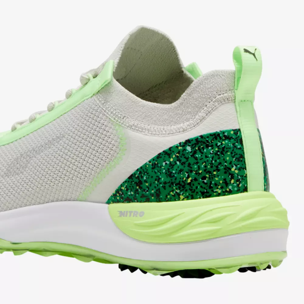 A close-up of the heel and side of a white and light green athletic shoe featuring a green glittery detail near the heel, mesh fabric, a white sole, and NITRO text on the midsole&mdash;perfect pairing for your best golf smartwatch.