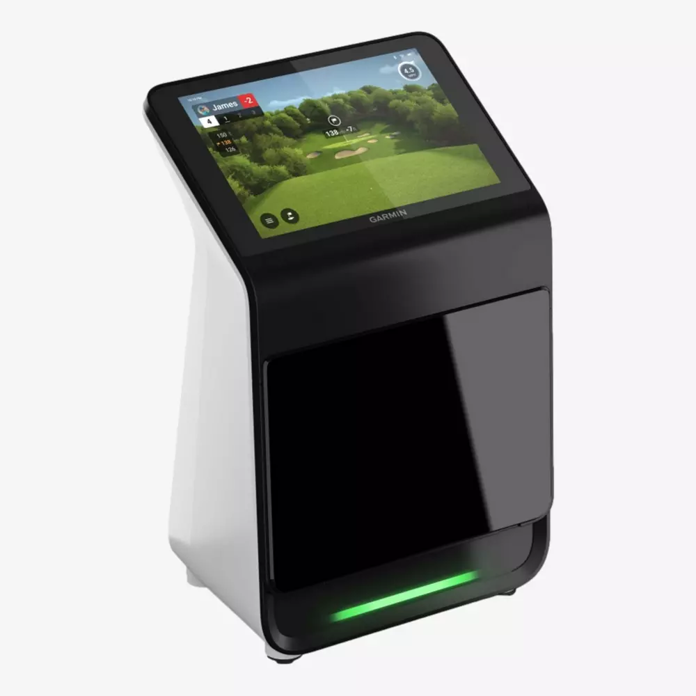A black and white Garmin device with a touchscreen displaying a golf simulation game, including a green landscape and game stats. Perfect for summer practice&mdash;even if you&rsquo;re considering if summer is the right time to buy rain gear. Yes!.
