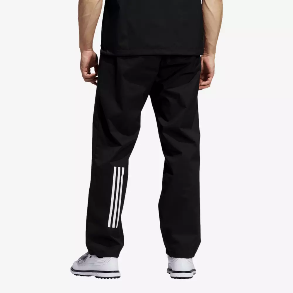 A person wearing black athletic pants with three white stripes on the lower left leg, a black shirt, and white sneakers, shown from the back against a plain background—perfect for viewing 6 golf deals worth buying now.