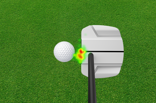 A Ping golf putter is about to strike a golf ball on grass, with a red and green heat map—captured using eye tracking glasses—highlighting the precise point of contact between the putter and the ball.