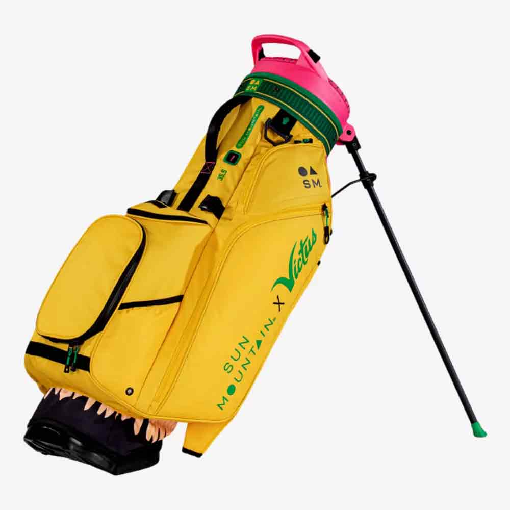 A vibrant Sun Mountain golf bag with green accents, a pink handle and a black carrycot. One pocket contains teeth and a pink interior, resembling a mouth. 