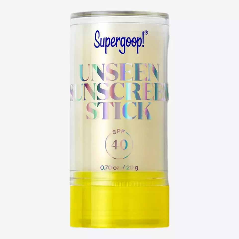 Supergoop clear stick! An invisible sunscreen with SPF 40, featuring glittery words on a transparent container and a bright yellow twist-on base—perfect for one of your Father's Day gifts.