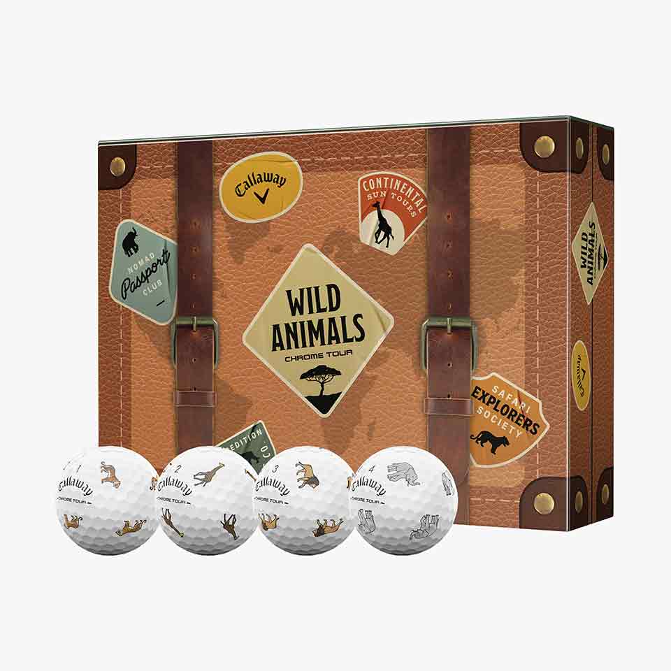 A suitcase-themed box labeled Wild Animals Chrome Tour with travel stickers evokes the spirit of adventure. In front, four white Callaway limited-edition golf balls each display small animal silhouettes—a perfect collector’s find for enthusiasts and fans alike. Shop this unique set to elevate your next round.