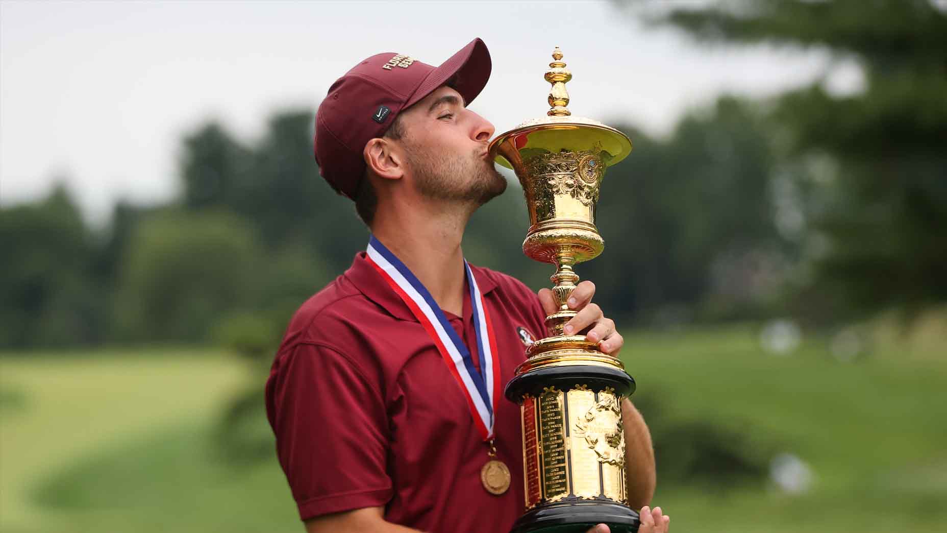 Jack Whaley kisses the Havemeyer Trophy