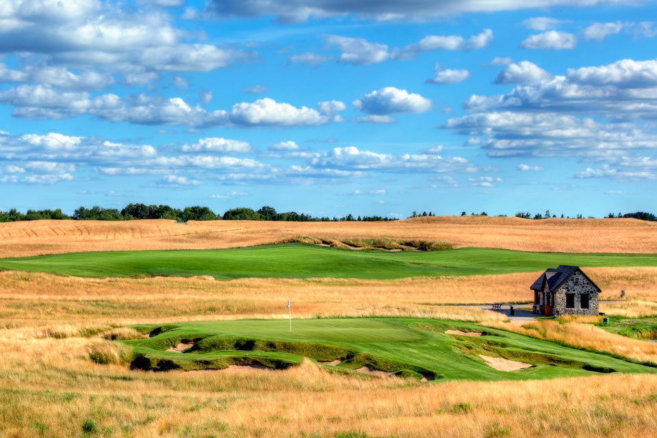 A view view of the No. 9 green, a 165-yard par 3, and Halfway House at Erin Hills Golf Course.